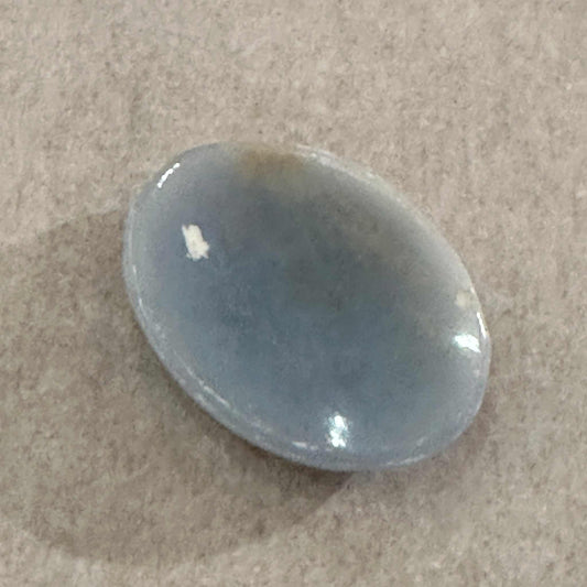 Smooth pale blue angelite palm stone with soft veining