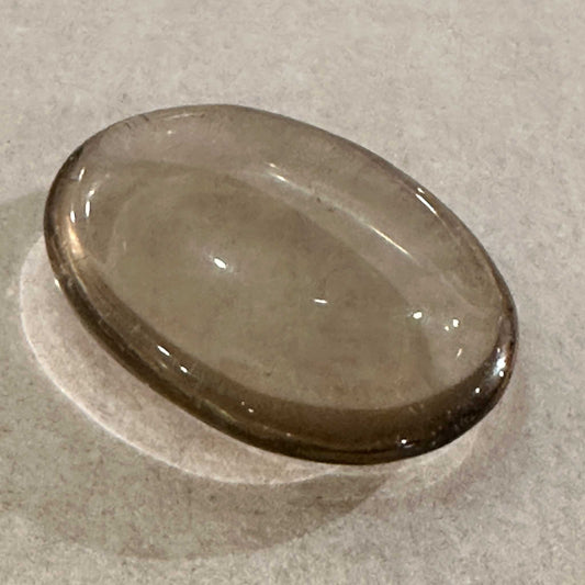 Smooth oval smoky quartz comfort stone in translucent grey-brown