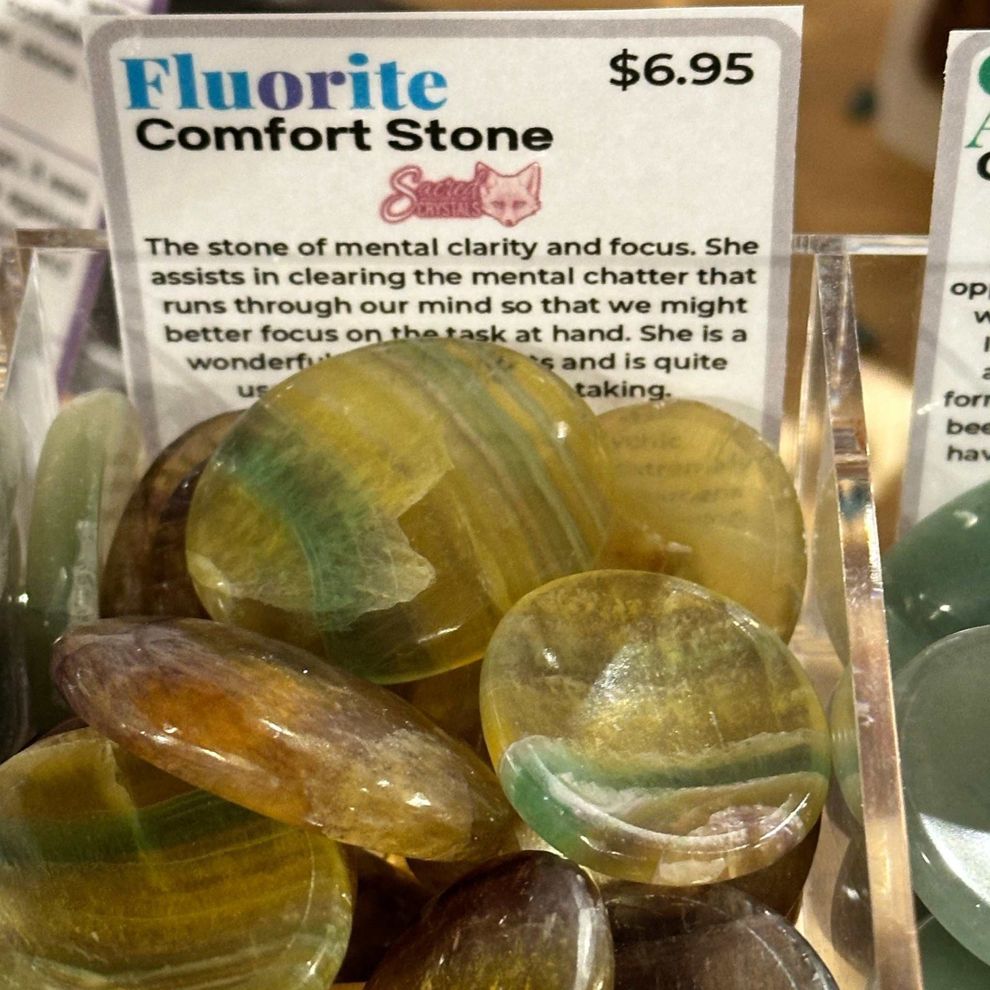 A fluorite comfort stone shown from another angle, showing its banded color.