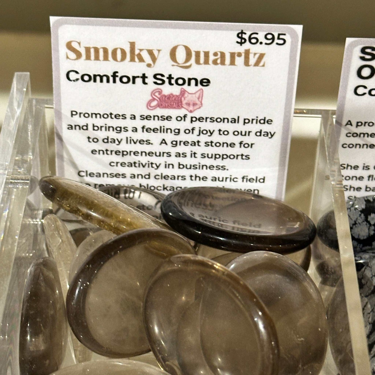 Smooth oval smoky quartz comfort stone in translucent grey-brown — shown from a second angle