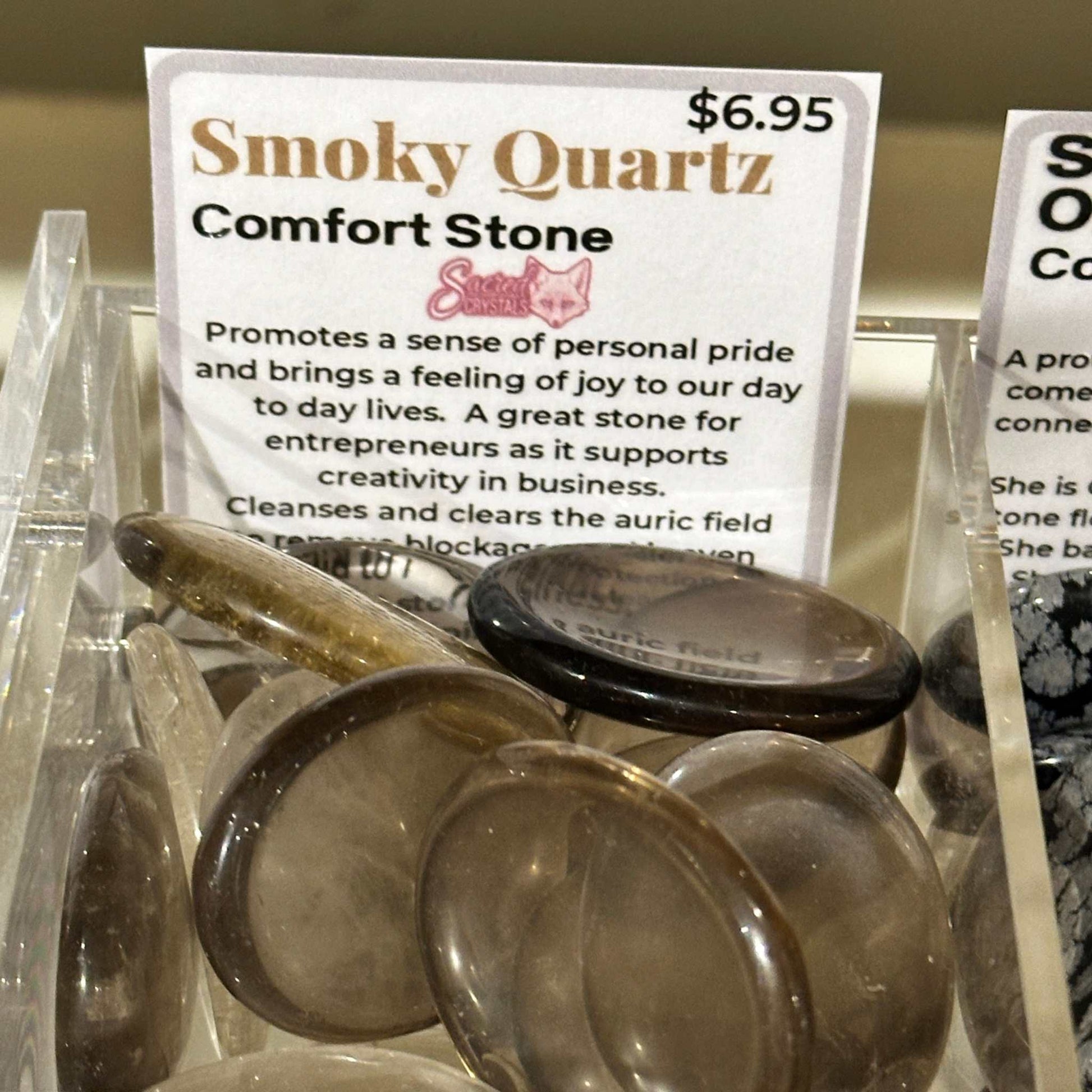 Smooth oval smoky quartz comfort stone in translucent grey-brown — shown from a second angle