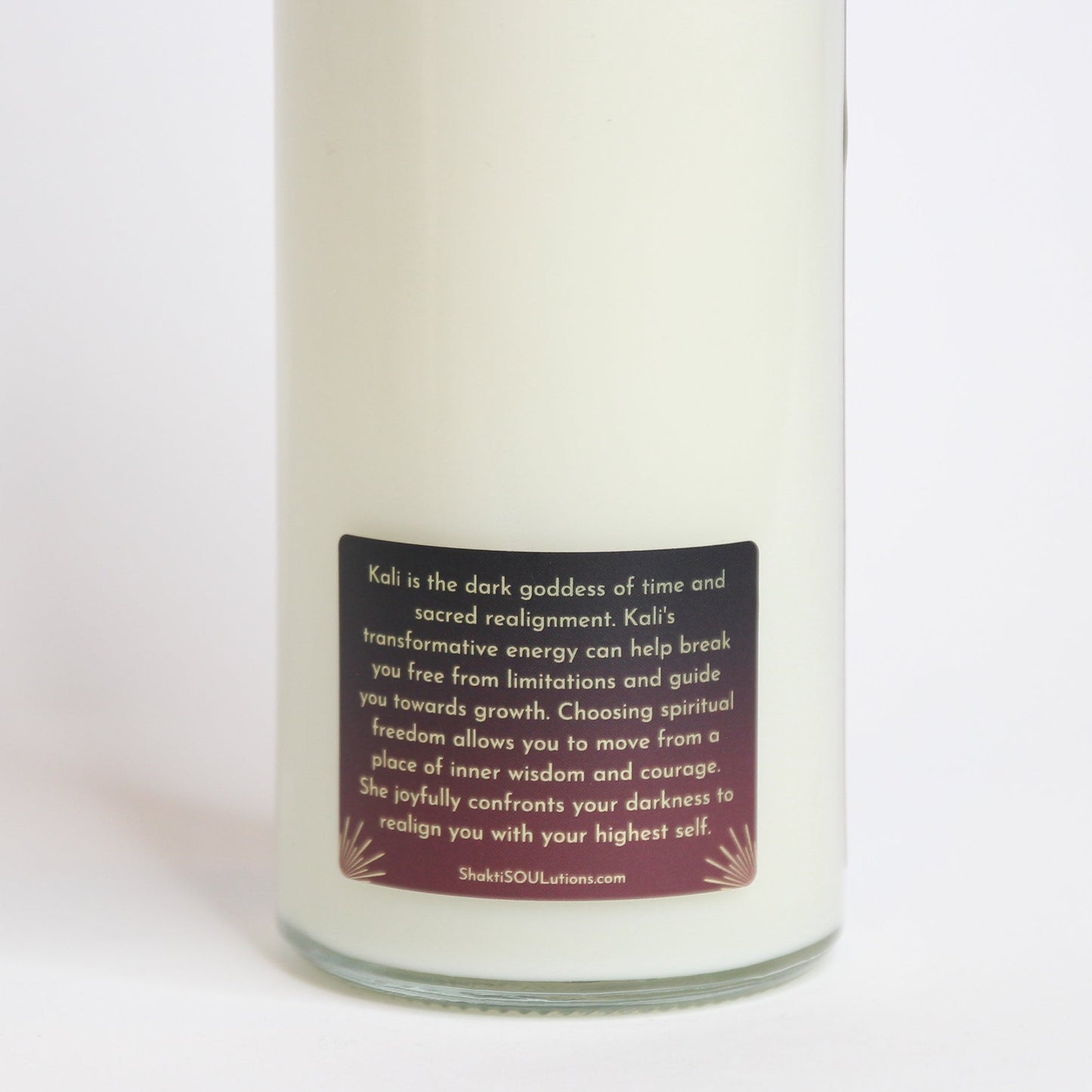 The Kali altar candle styled on a dark altar surface
