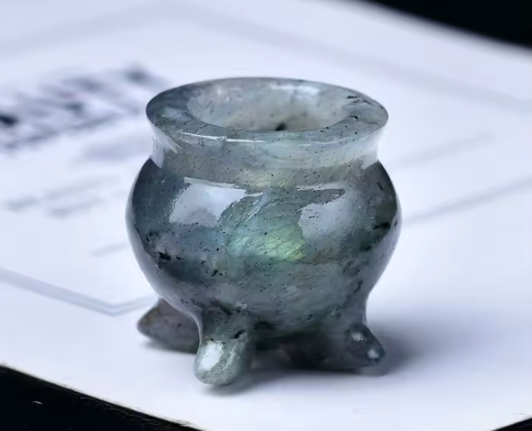 Small carved crystal cauldron with two handles, shown as an altar piece and crystal sphere stand — product photo 3