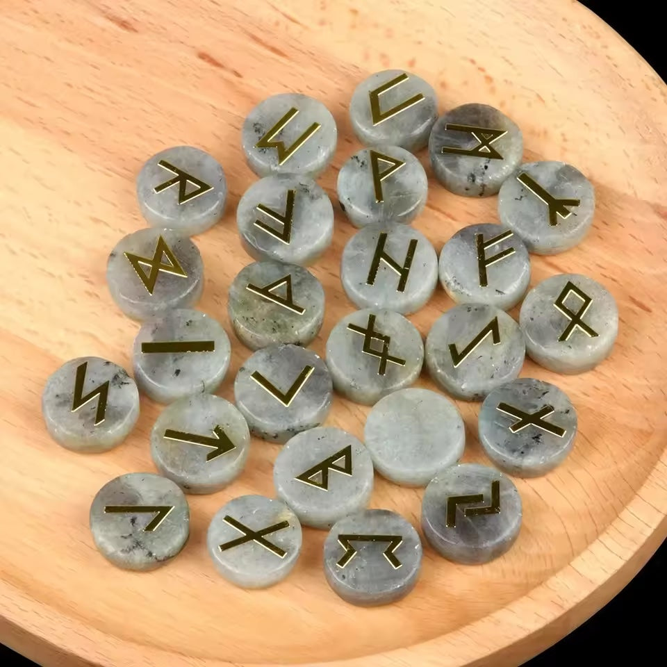 Set of round polished crystal runes engraved with runic symbols, scattered on a dark surface — view 7 of 12
