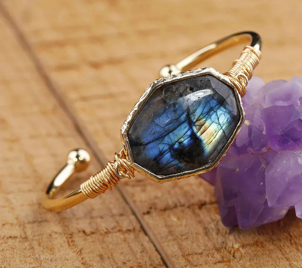 Open bangle cuff bracelet set with a large octagonal labradorite stone showing blue and green flash — product photo 2