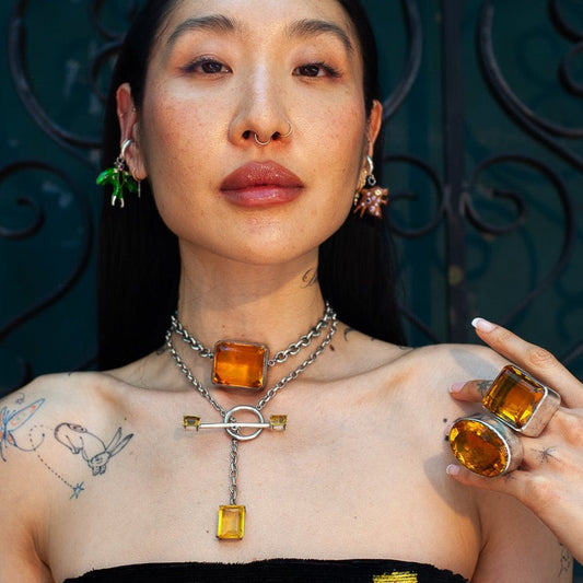 Model wearing the Square Goliath choker, amber stone at the throat and a second stone dropping below