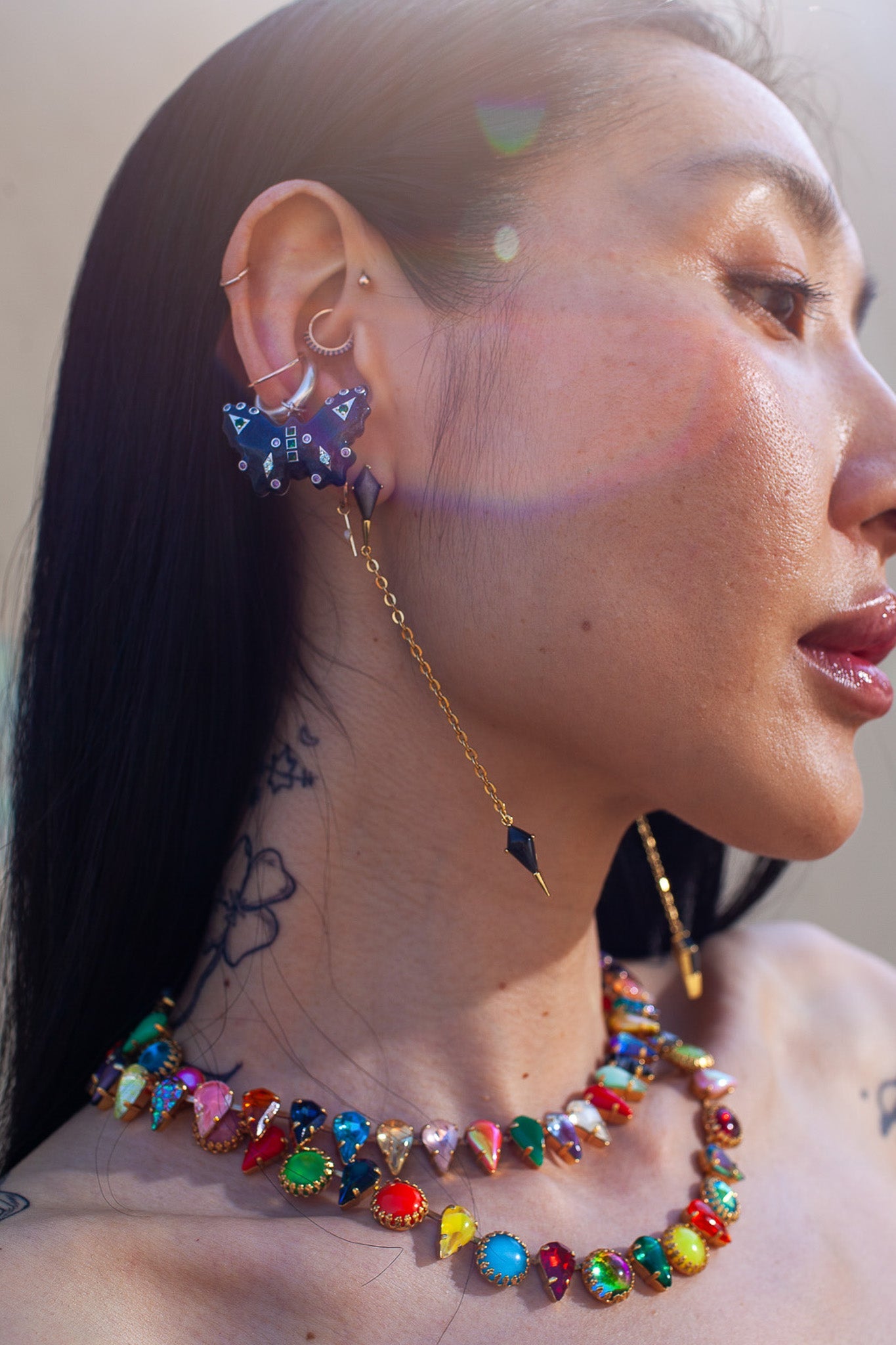 Detail of the enamel butterfly charm set with glass crystals