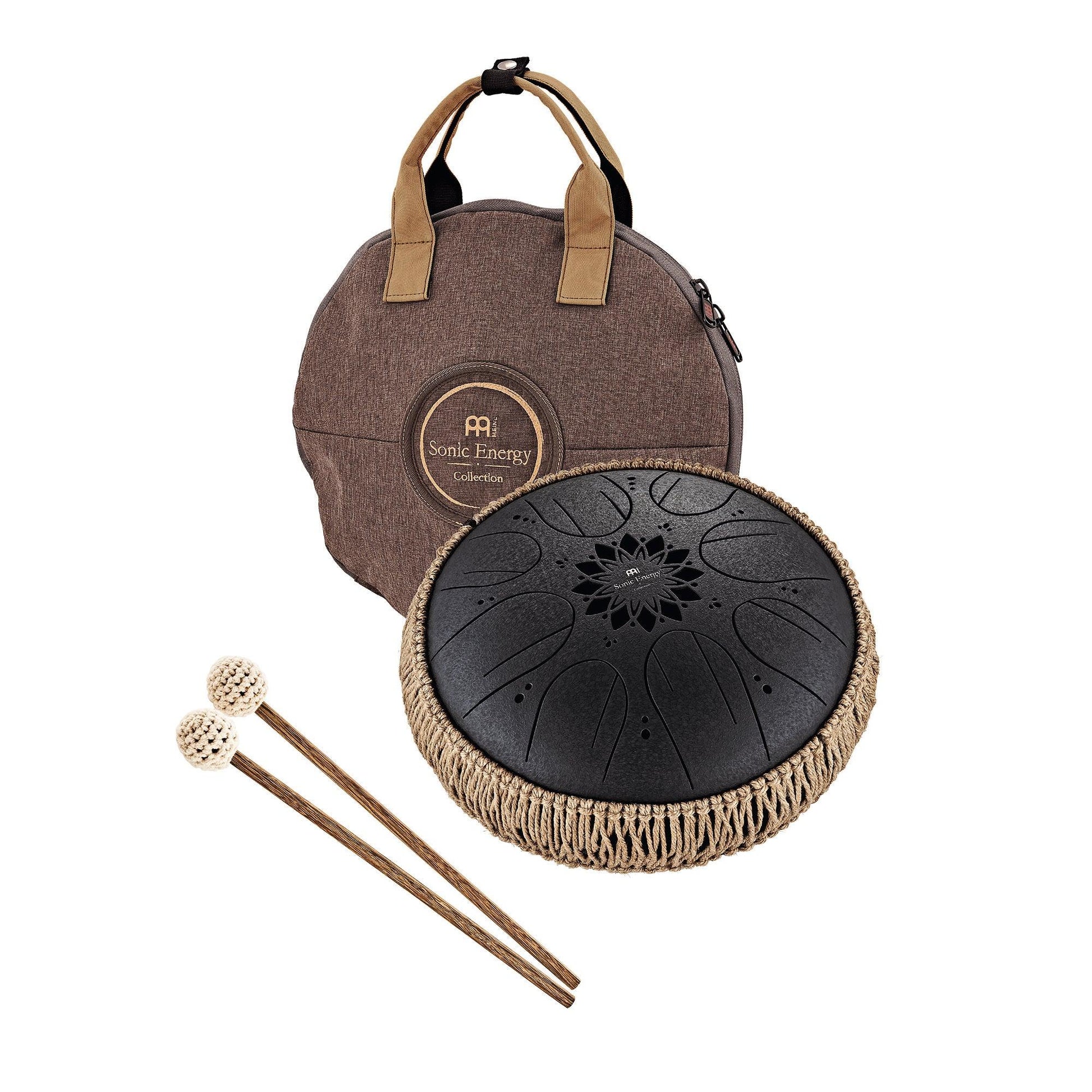 Black 10-inch steel tongue drum shown in a warm, styled tabletop arrangement.