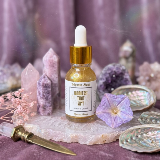 A small glass bottle of Manifest That Sh*t Ritual Oil for abundance and intention work.