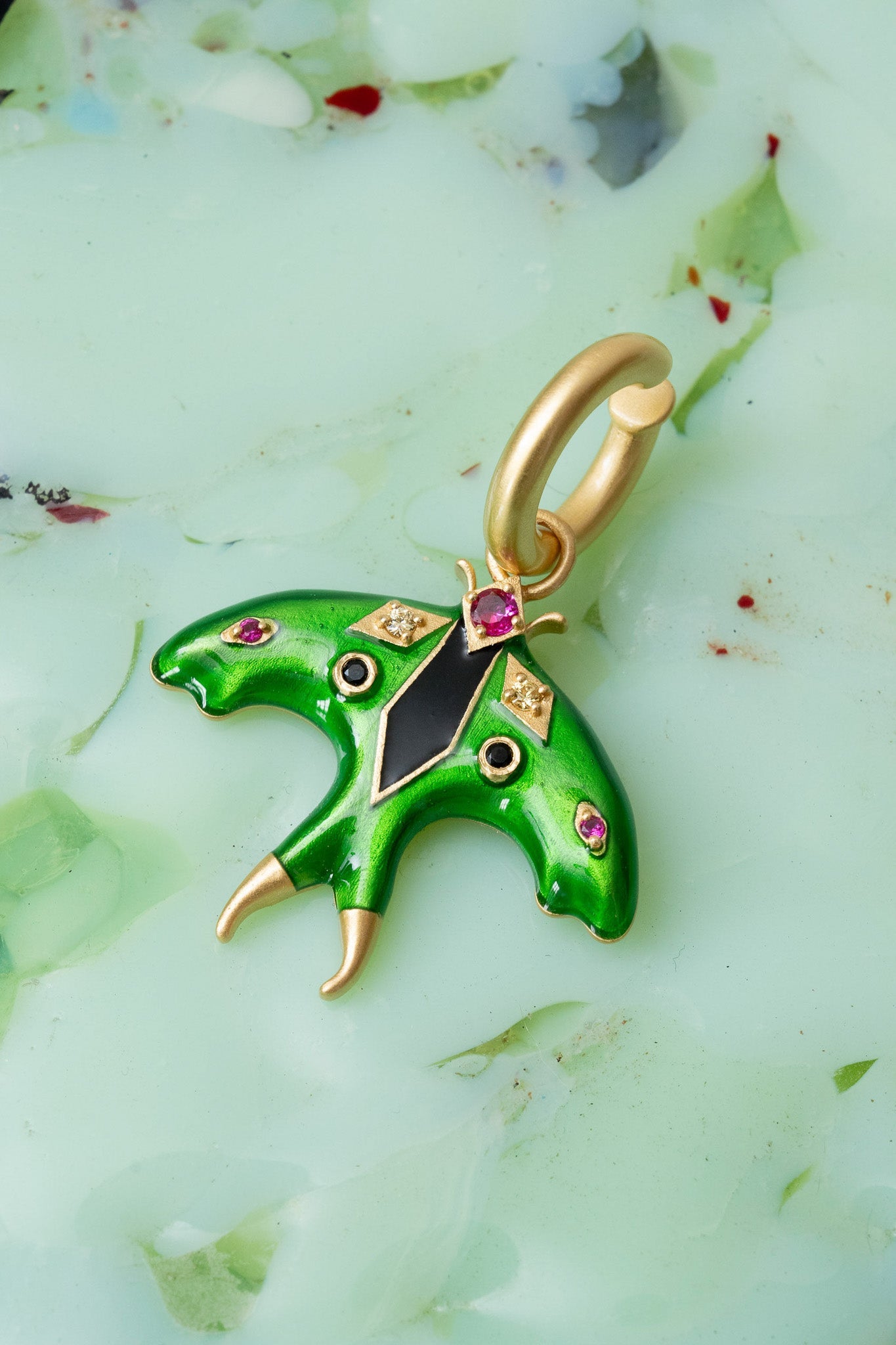 Luna Moth Enamel Ear Cuff in gold — iridescent enamel moth charm set with glass crystals and genuine onyx, worn on the upper ear