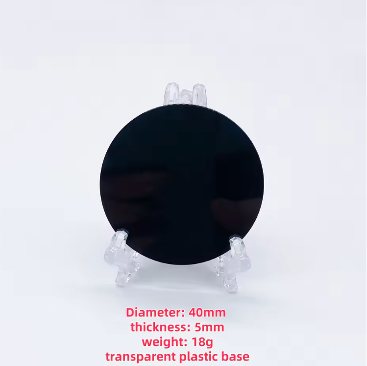 Round polished black obsidian scrying mirror resting on its base stand — view 7 of 11