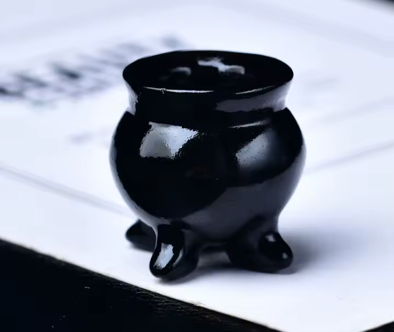 Small carved crystal cauldron with two handles, shown as an altar piece and crystal sphere stand — product photo 5