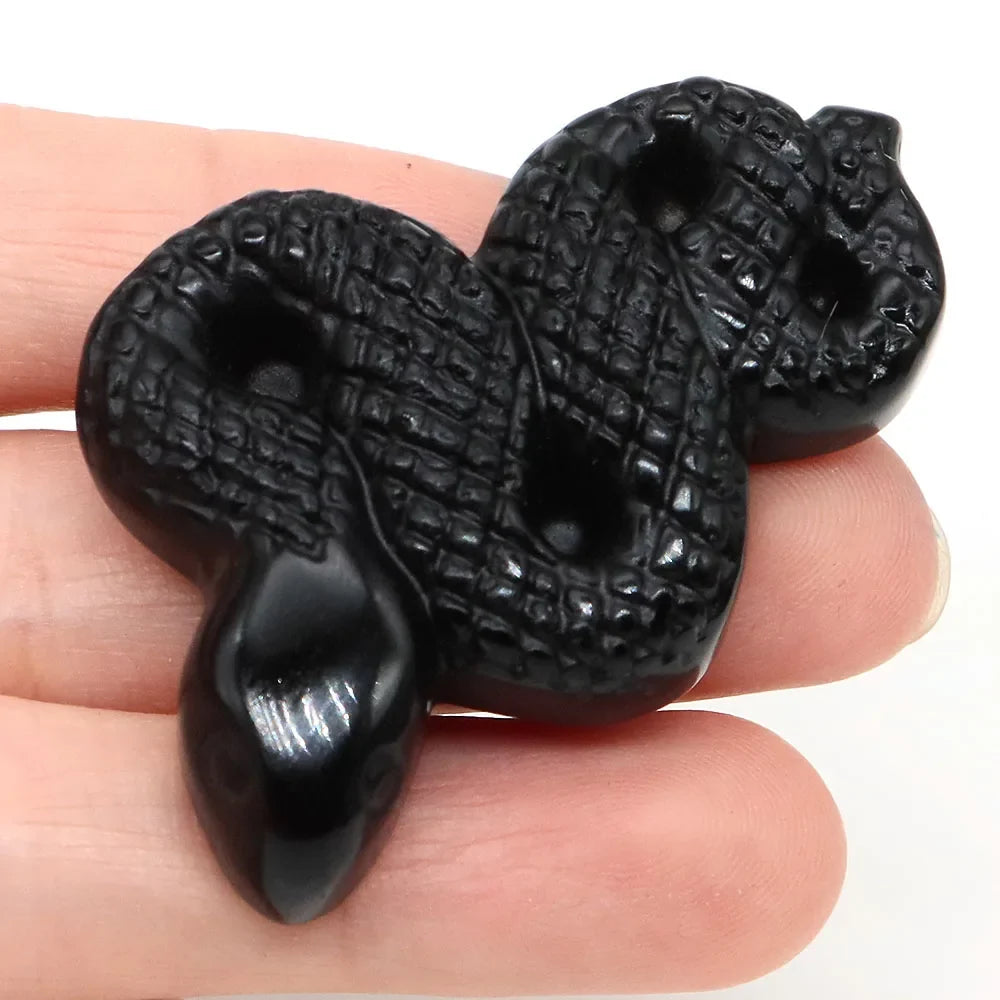 Carved gemstone snake figurine coiled on a dark surface — view 12 of 12