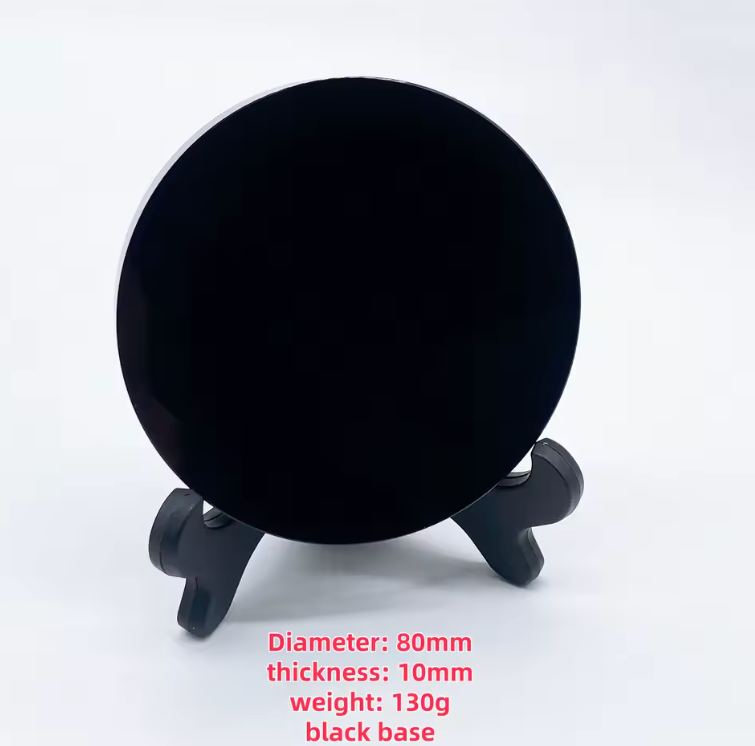 Round polished black obsidian scrying mirror resting on its base stand — view 9 of 11