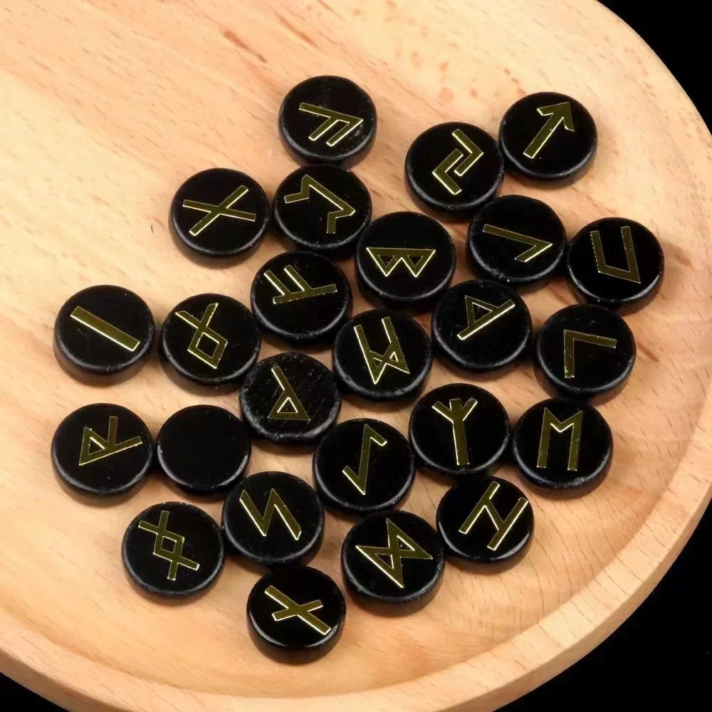 Set of round polished crystal runes engraved with runic symbols, scattered on a dark surface — view 9 of 12