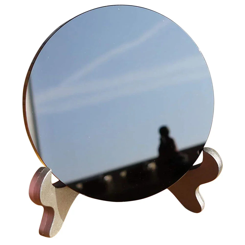 Round polished black obsidian scrying mirror resting on its base stand — view 3 of 11