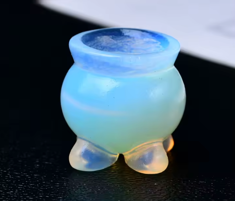 Small carved crystal cauldron with two handles, shown as an altar piece and crystal sphere stand — product photo 2
