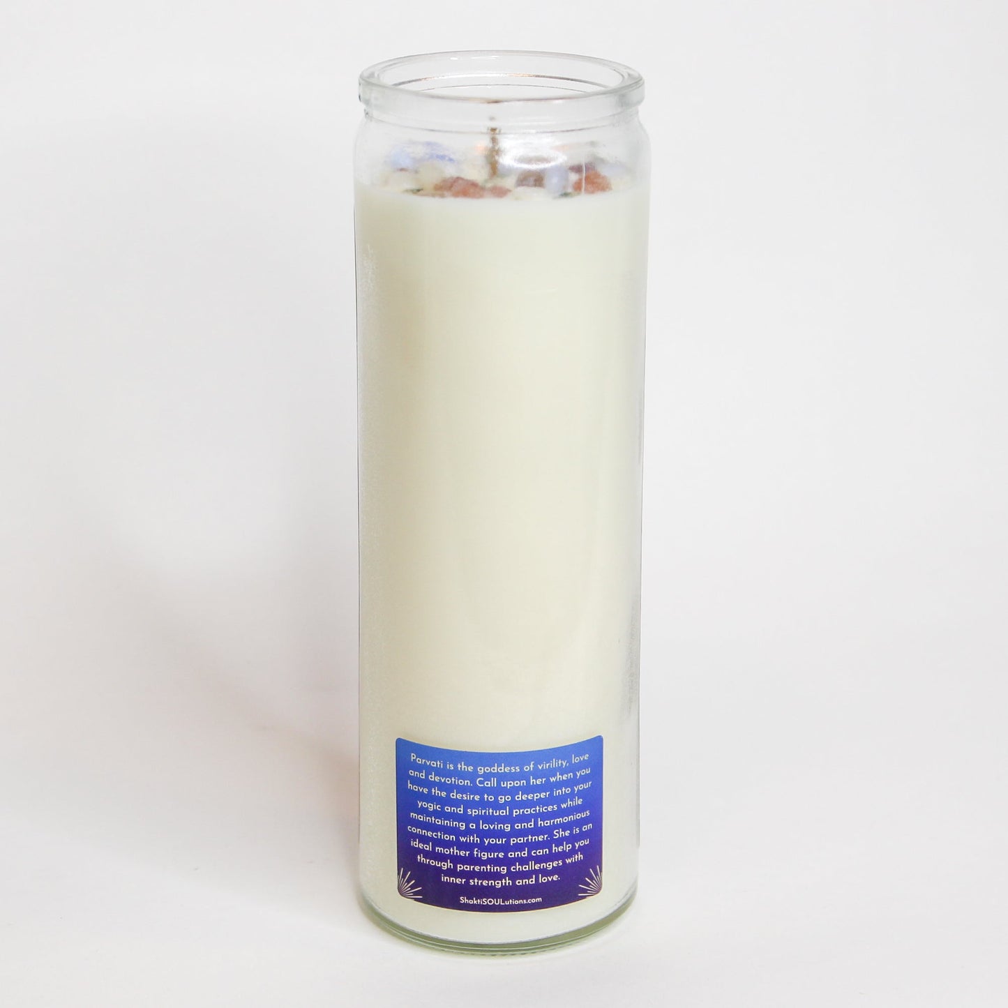 The Parvati altar candle styled on a dark altar surface