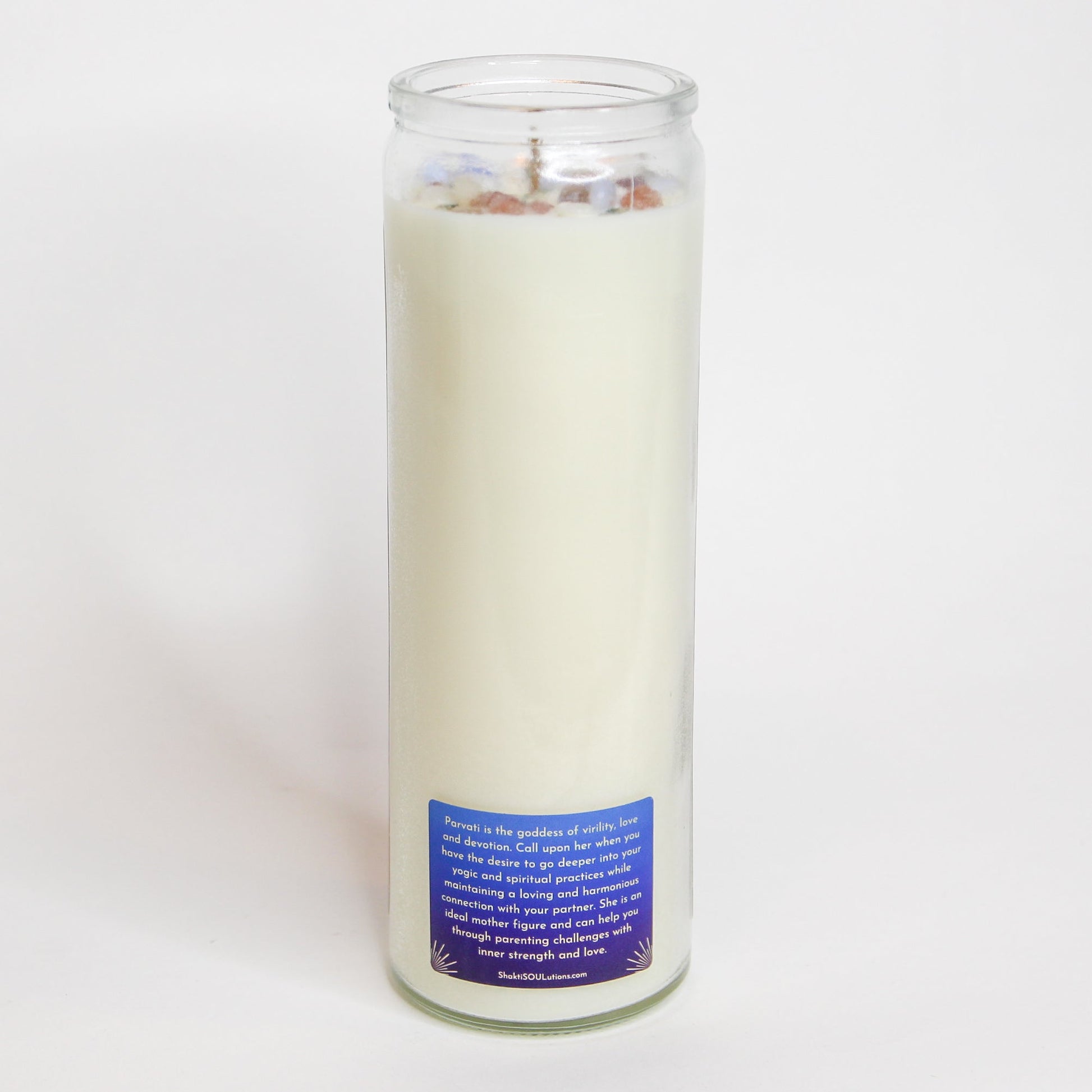 The Parvati altar candle styled on a dark altar surface
