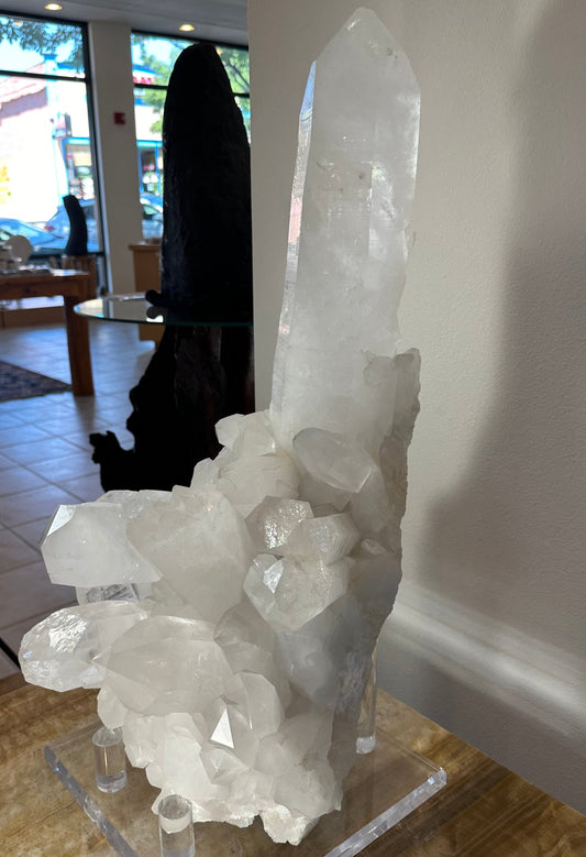 Large quartz crystal cluster with an extra-large central point on its acrylic stand