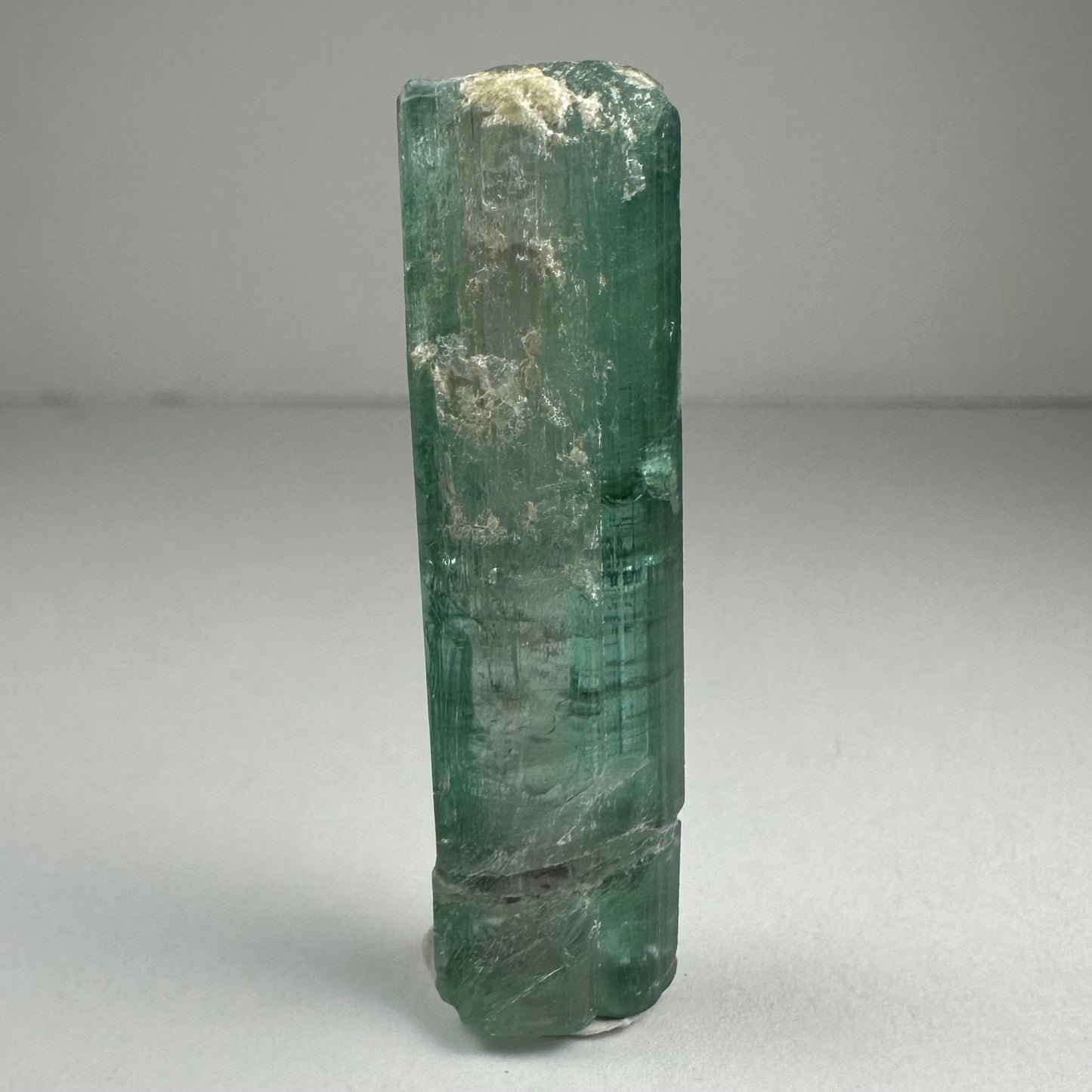 Blue indicolite tourmaline crystal specimen from Africa, 1.5 inches long, photographed against a dark background — view 2