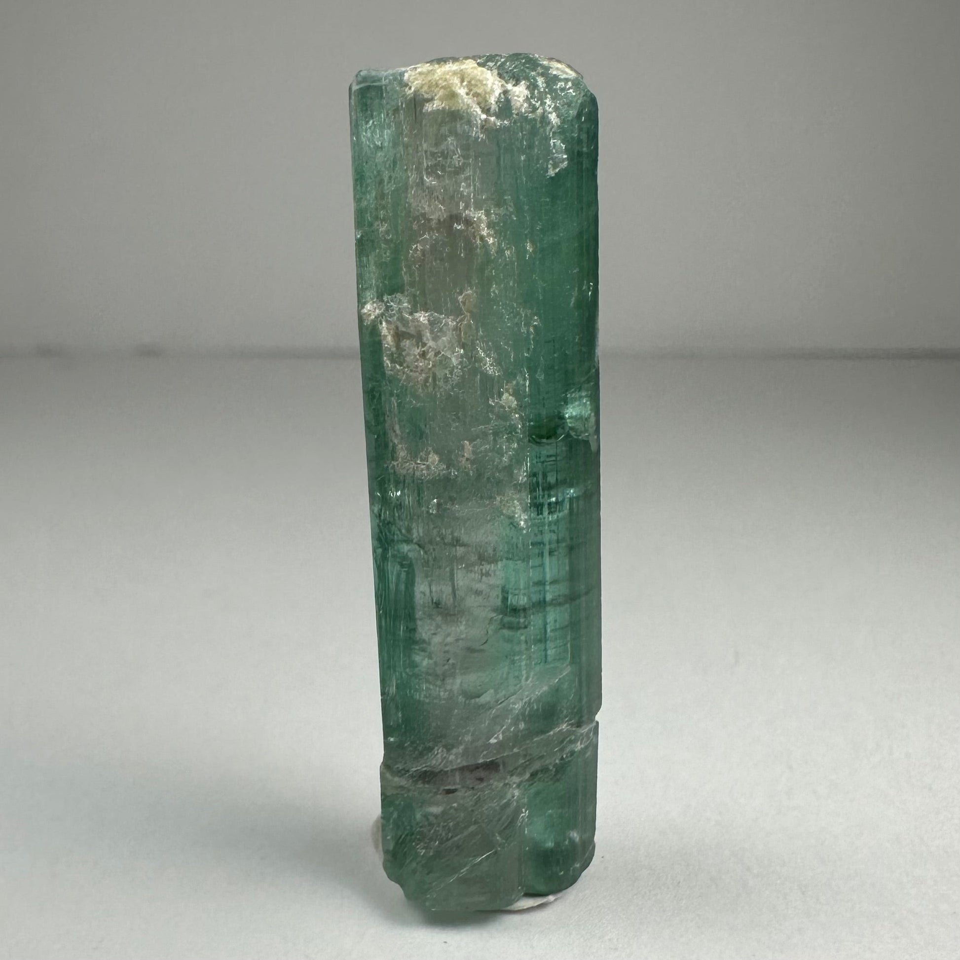 Blue indicolite tourmaline crystal specimen from Africa, 1.5 inches long, photographed against a dark background — view 2