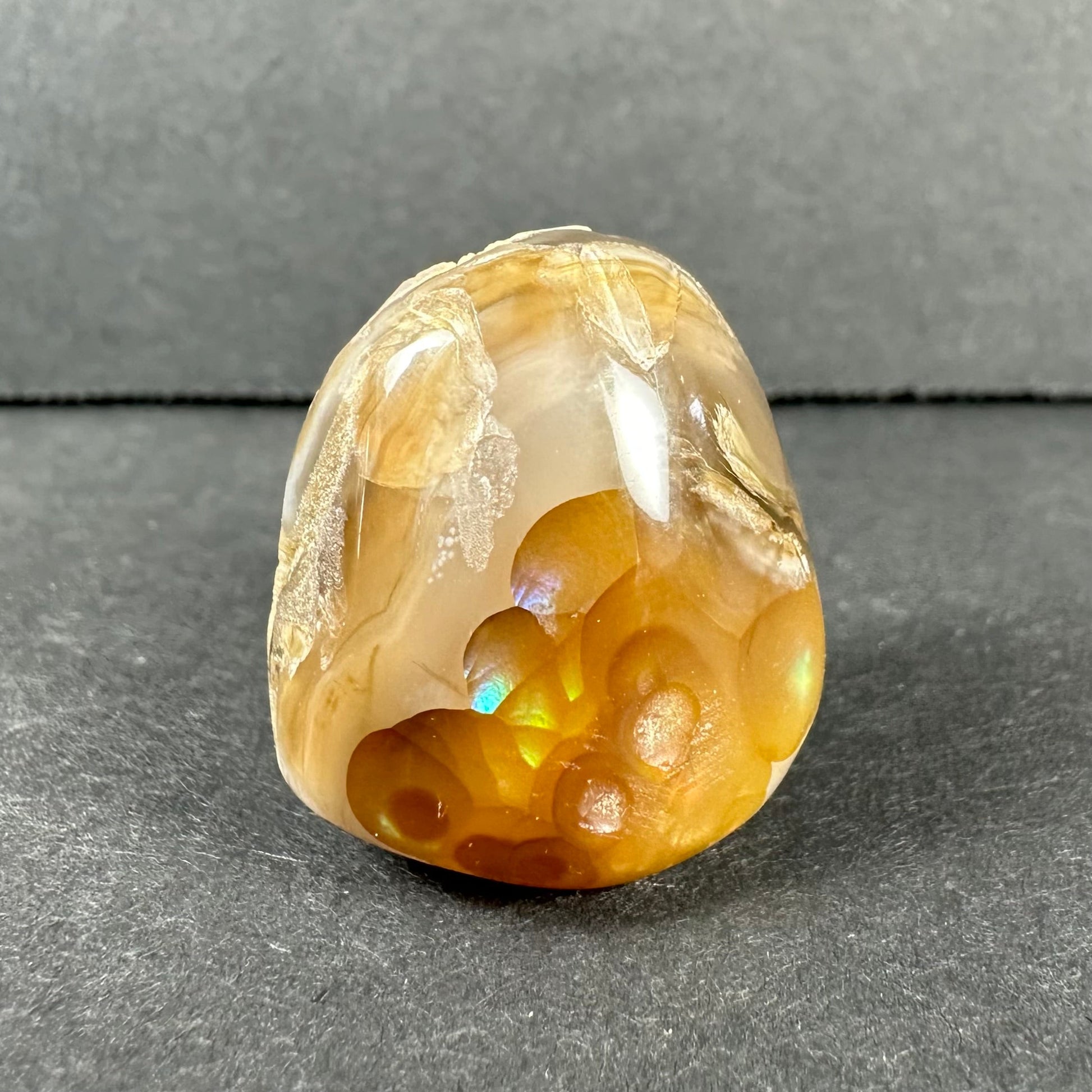 Fire agate against a dark background showing its play of colour