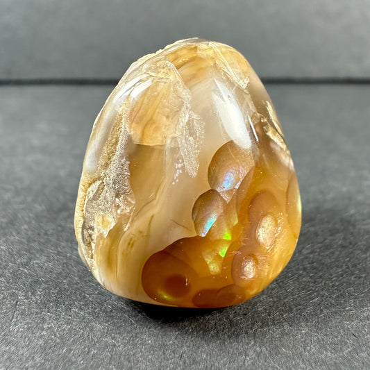 Fire agate specimen showing iridescent orange and green flashes