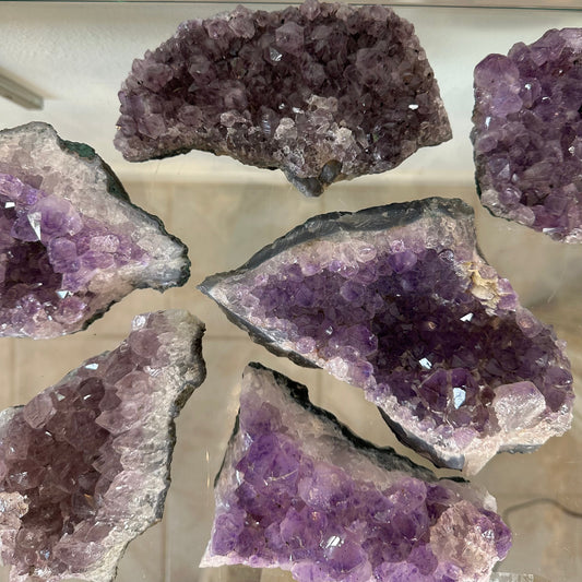 Raw Brazilian amethyst druze piece with a crust of purple crystal points