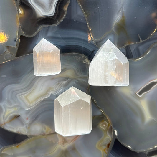 Small translucent white selenite obelisk tower from Morocco, four-sided point about two inches tall