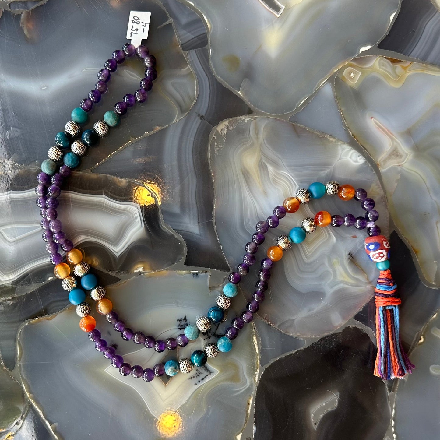 Detail of the amethyst, carnelian and blue apatite beads on the mala
