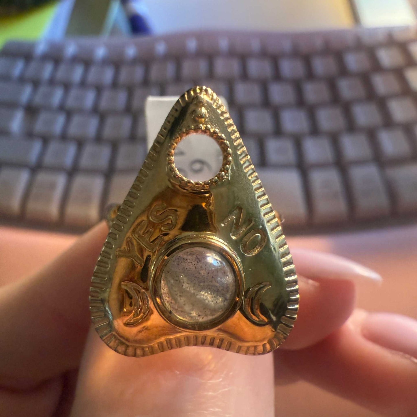 Planchette-shaped ring with a labradorite cabochon and an open viewing window at the tip