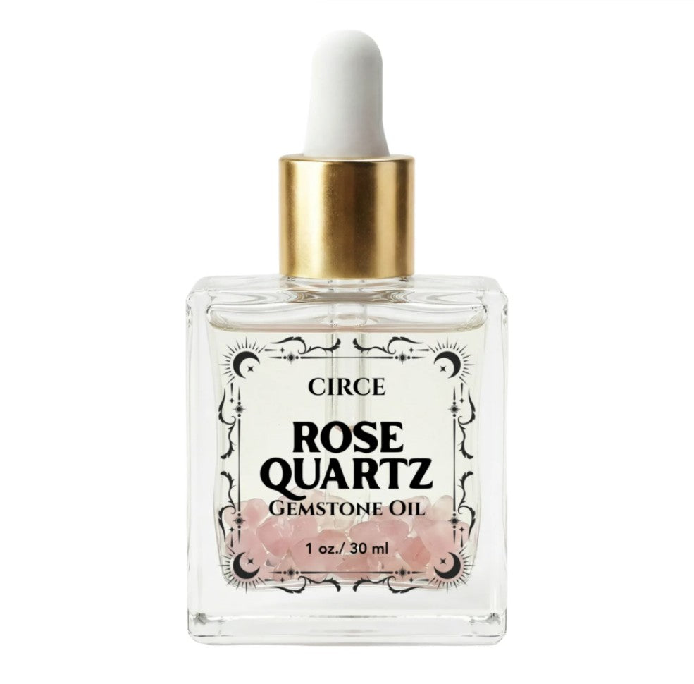 Rose quartz gemstone shimmer body oil in an apothecary glass bottle with rose quartz crystals (view 6)