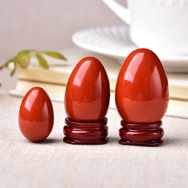 Polished carved crystal egg in assorted gemstones on a dark surface — view 10 of 10