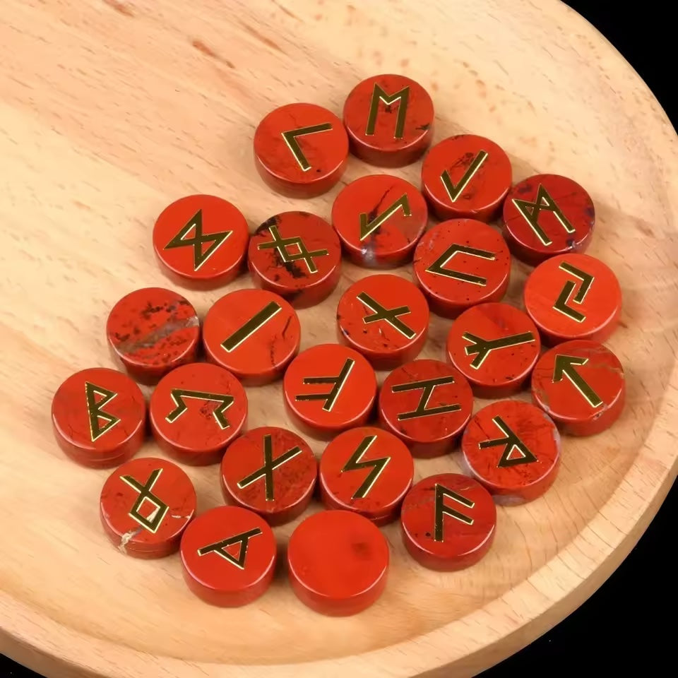 Set of round polished crystal runes engraved with runic symbols, scattered on a dark surface — view 11 of 12