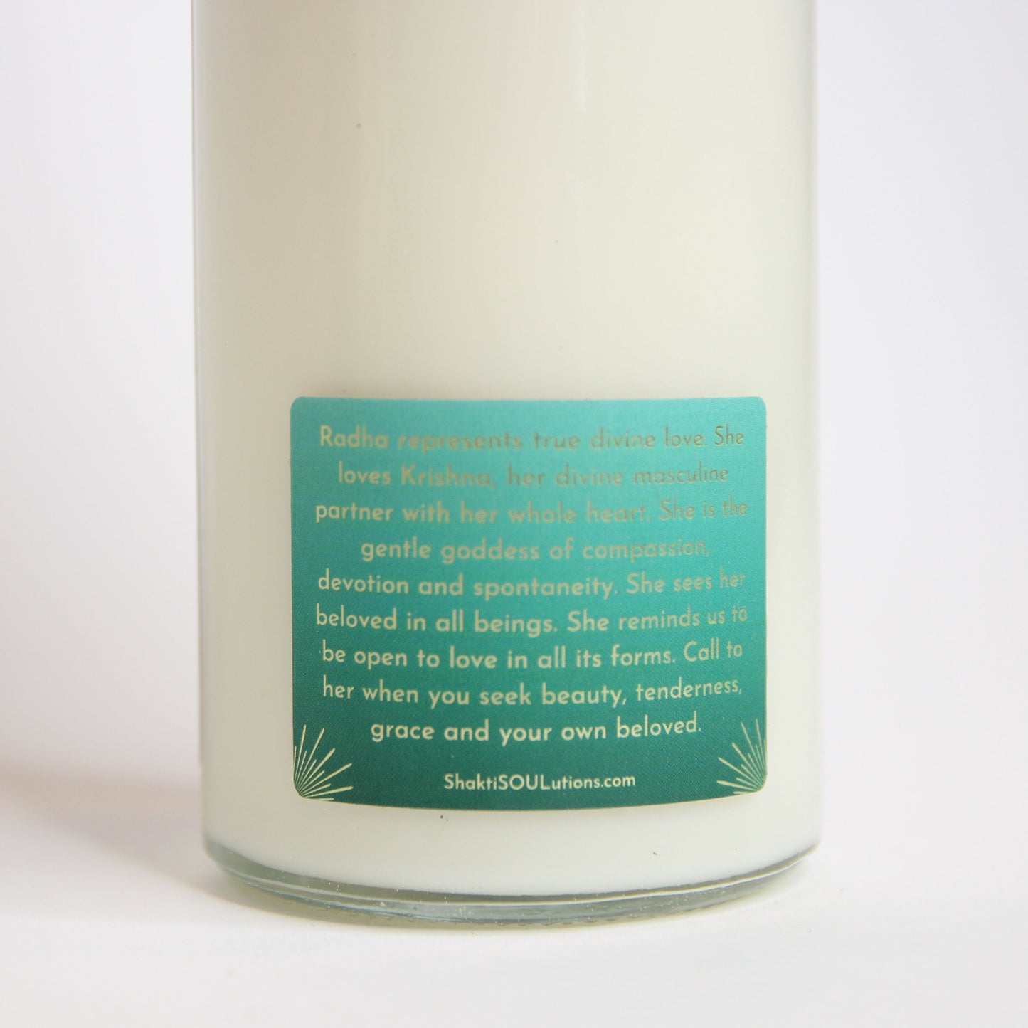 Radha Crystal Altar Candle in a 16 oz glass tumbler with an image of the goddess Radha on the label and rose quartz set into the wax — product photo 5