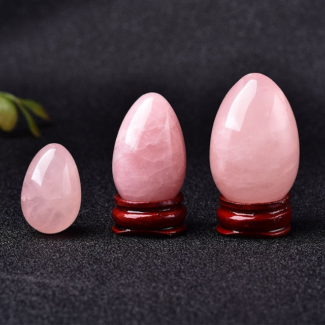 Polished carved crystal egg in assorted gemstones on a dark surface — view 3 of 10