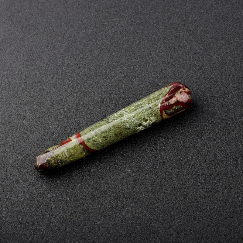 Smooth polished crystal massage wand in assorted gemstones on a dark surface — view 9 of 12