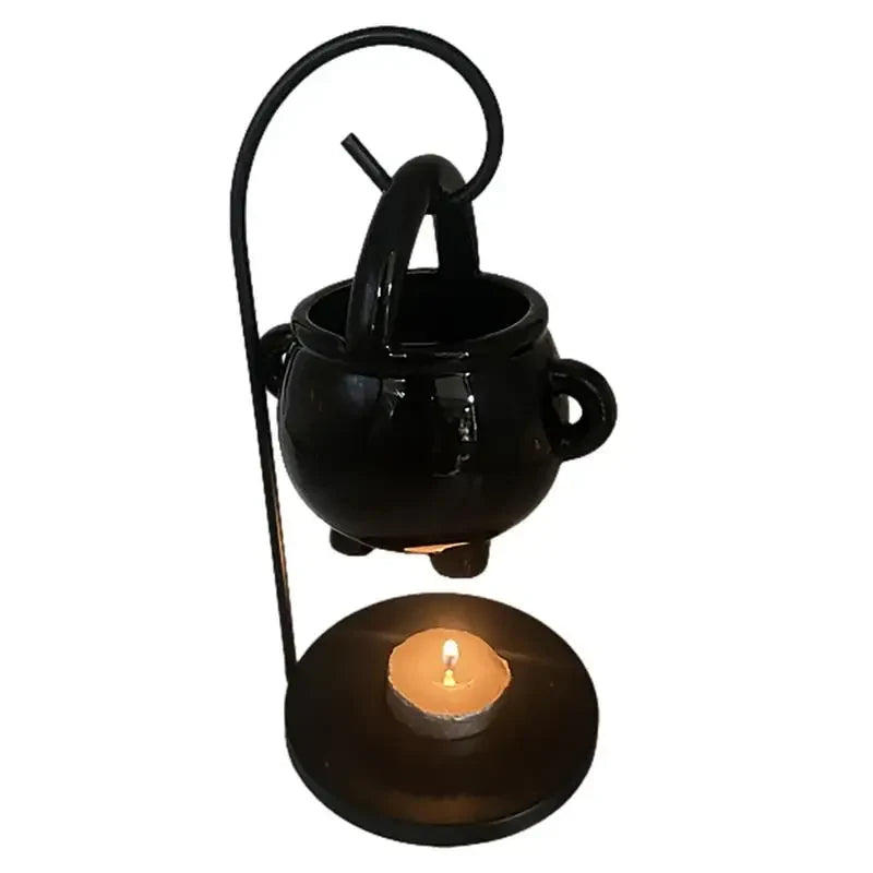 Hanging ceramic cauldron wax burner suspended from a black metal stand — view 2 of 5