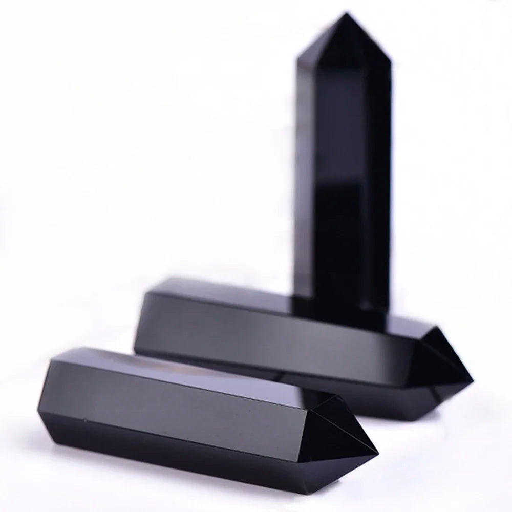 Four-sided polished crystal obelisk tower standing upright on a dark surface — view 7 of 9