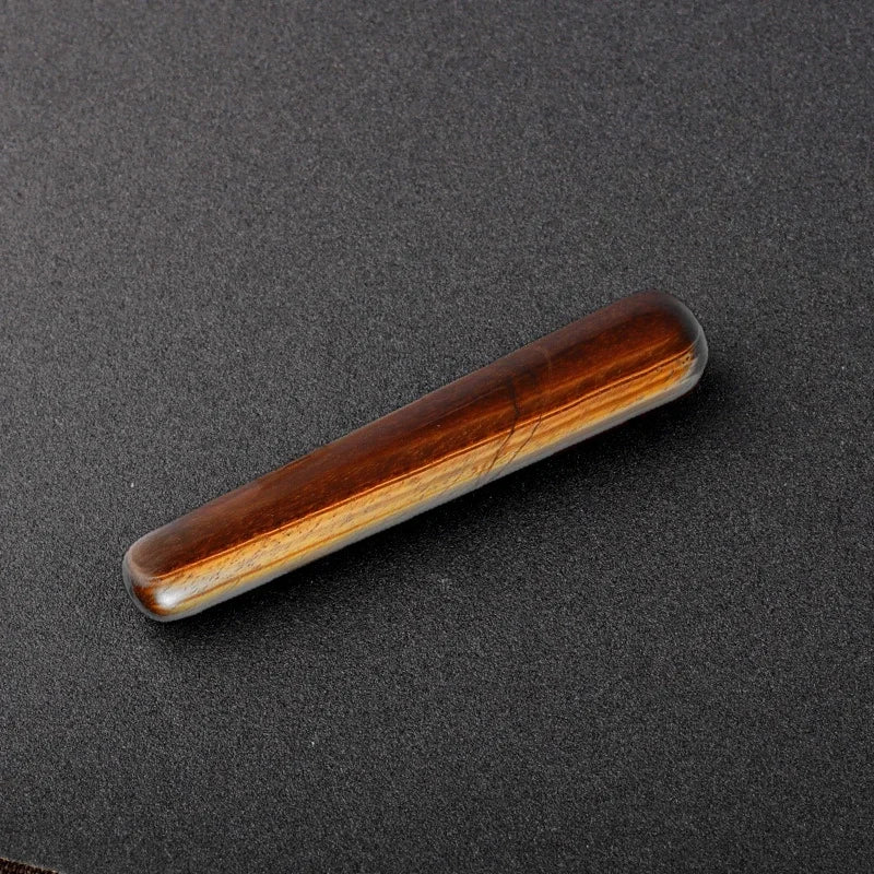 Smooth polished crystal massage wand in assorted gemstones on a dark surface — view 6 of 12