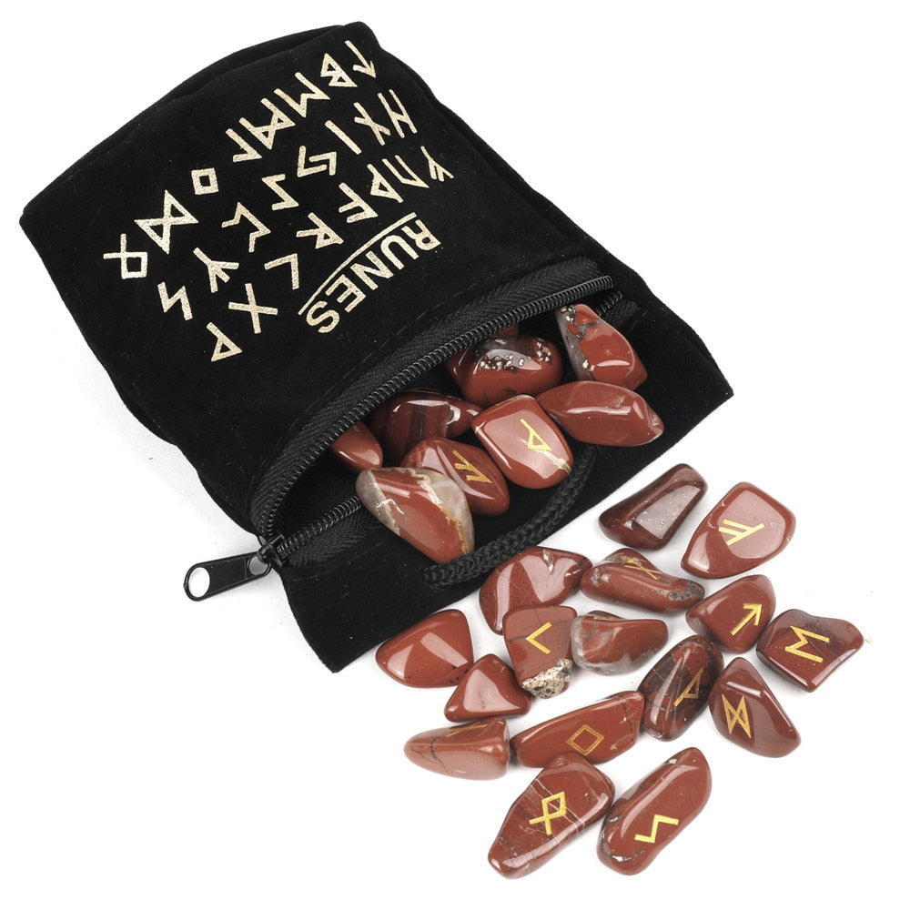 Set of twenty-five carved crystal runes laid out beside a velvet drawstring storage bag — product photo 4