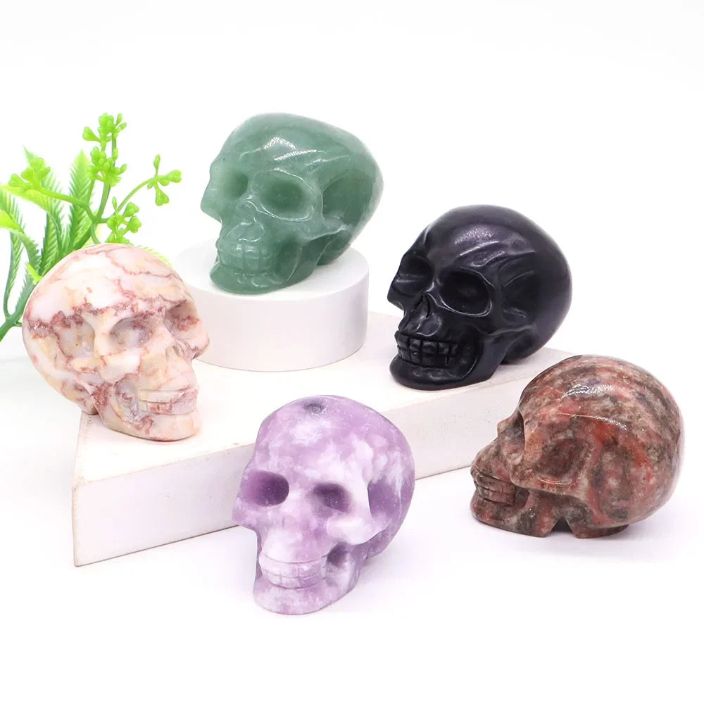 Carved gemstone crystal skull sculpture on a dark surface — view 2 of 12