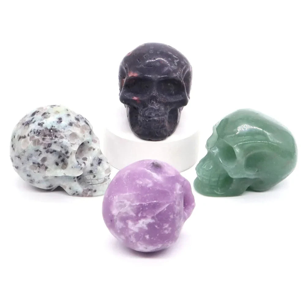 Carved gemstone crystal skull sculpture on a dark surface — view 5 of 12