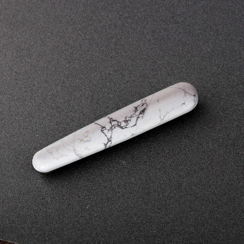 Smooth polished crystal massage wand in assorted gemstones on a dark surface — view 7 of 12