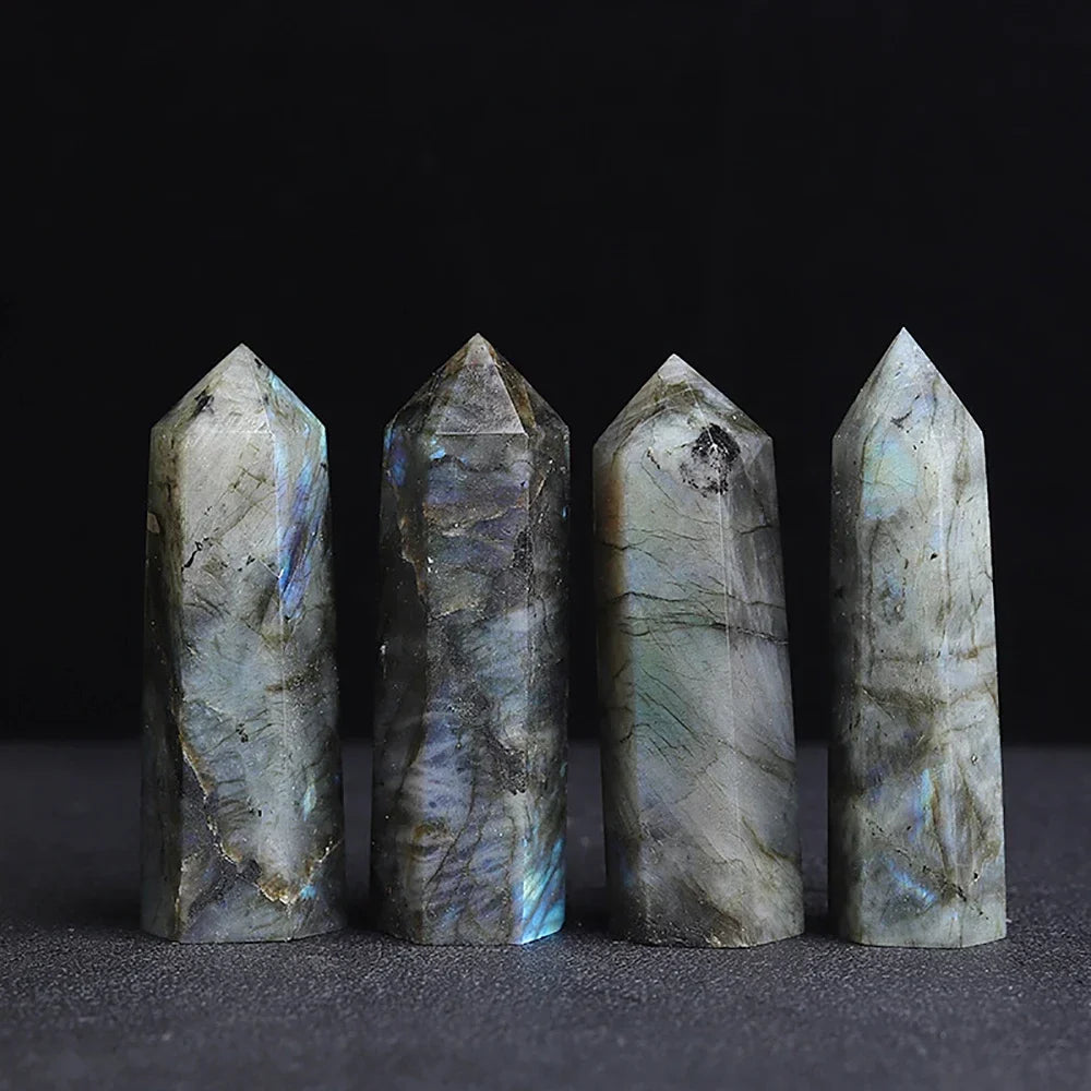 Four-sided polished crystal obelisk tower standing upright on a dark surface — view 5 of 9