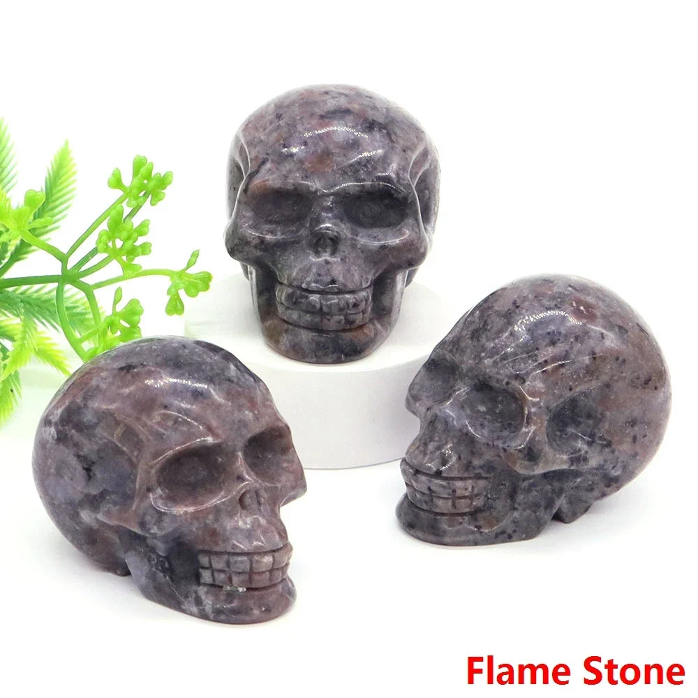 Carved gemstone crystal skull sculpture on a dark surface — view 10 of 12