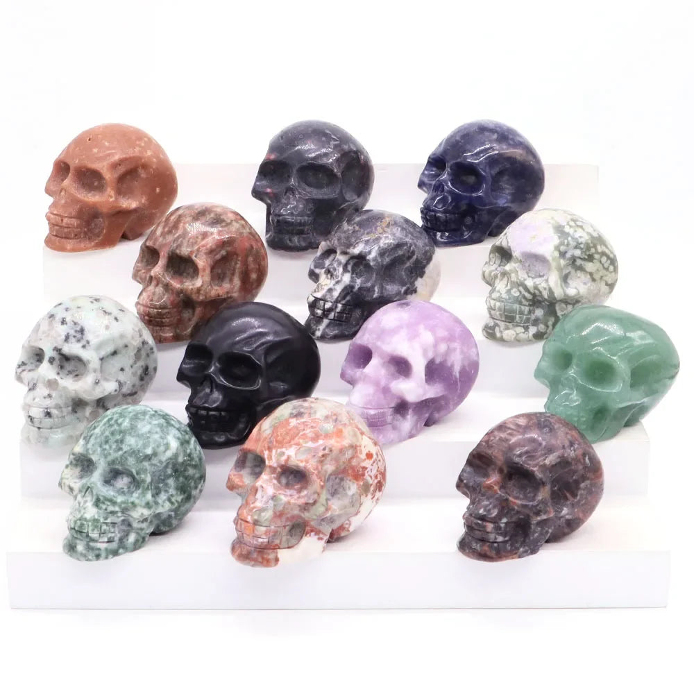 Carved gemstone crystal skull sculpture on a dark surface — view 6 of 12