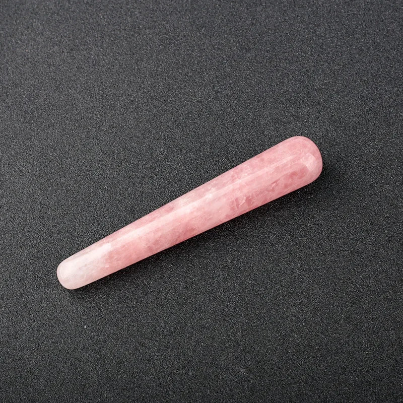 Smooth polished crystal massage wand in assorted gemstones on a dark surface — view 2 of 12