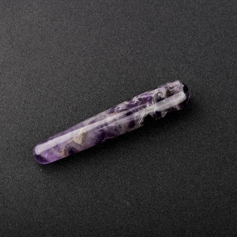 Smooth polished crystal massage wand in assorted gemstones on a dark surface — view 3 of 12